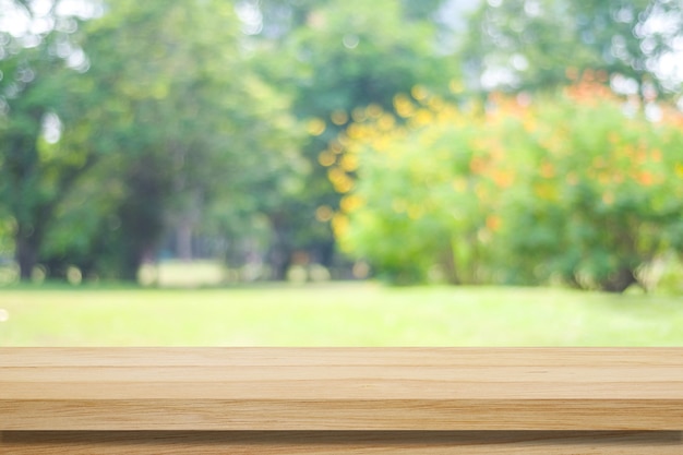 Empty wooden table over blurred tree with bokeh background