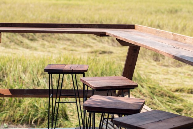 Empty wooden table chaiir  with view spring summer rice field Asia landscape background