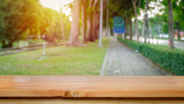 Empty wooden table on green nature background