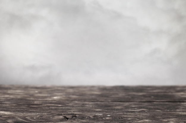 Empty wooden table on a grey smoke background