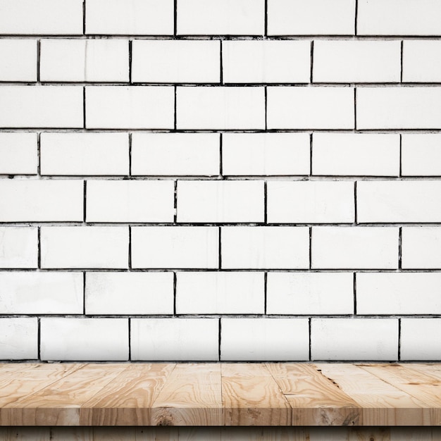 Empty wooden table top and white brick wall and rough crack background texture