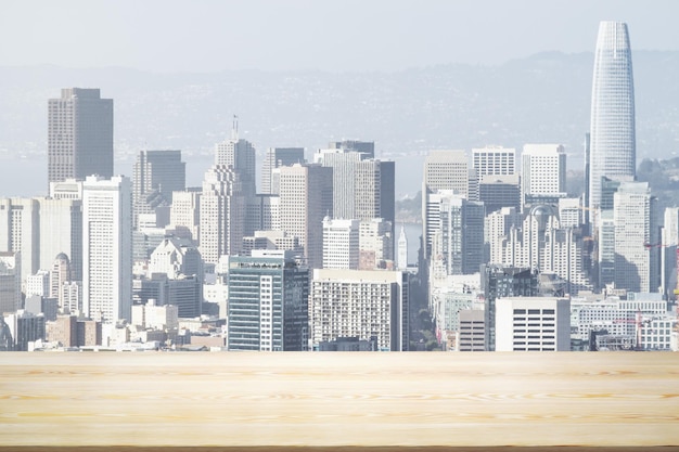 Empty wooden table top with beautiful San Francisco skyscrapers at daytime on background mock up