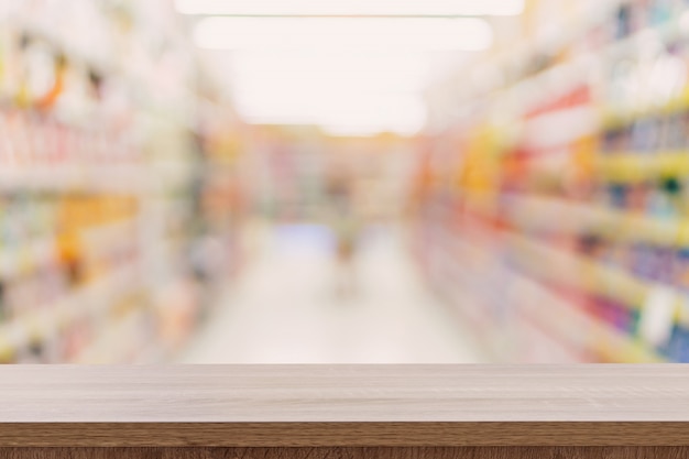 Empty wooden table top with blurred modern shopping mall