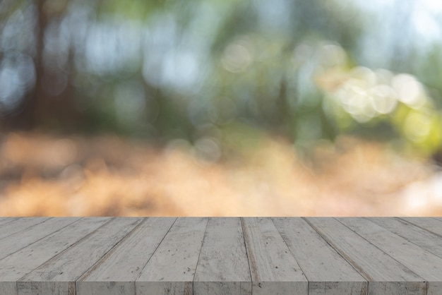 Empty wooden table top with bokeh on blurred nature background