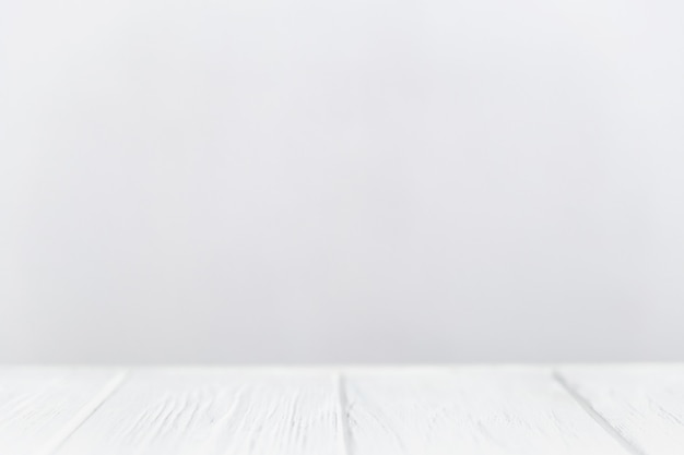 Empty wooden table white white wall background with copy space.