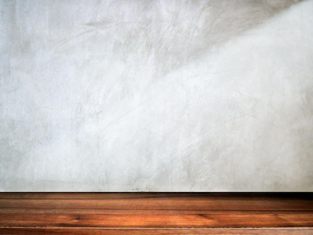 Empty wooden table with grunge cement background