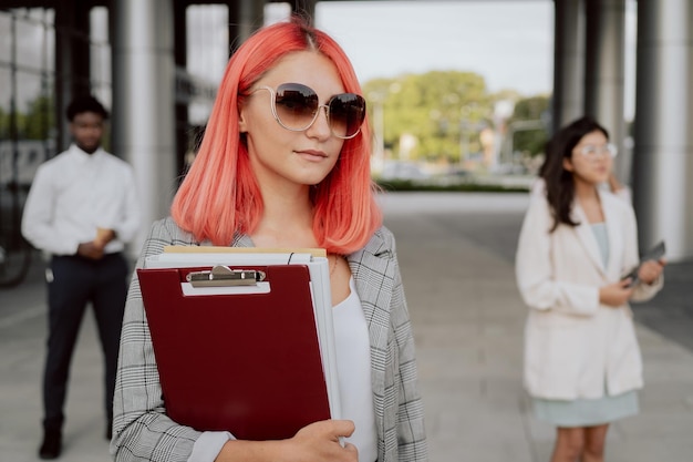 End of work in office coworkers walk outside from company building young business people