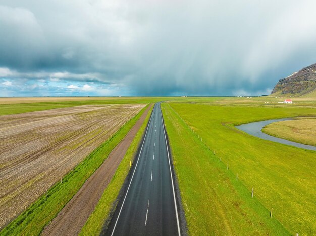 Endless road into the cloudy mountains and hills of iceland during sunny cloudy weather