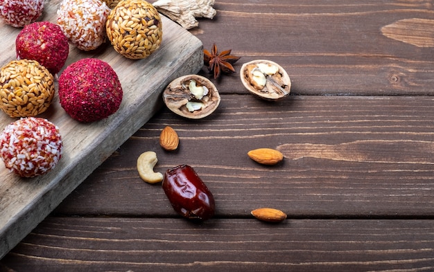 Energy balls on an old wooden board and on a wooden background.