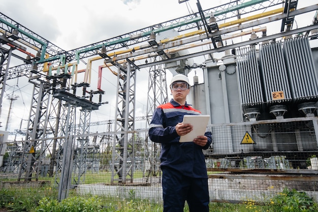 The energy engineer inspects the equipment of the substation. Power engineering. Industry.