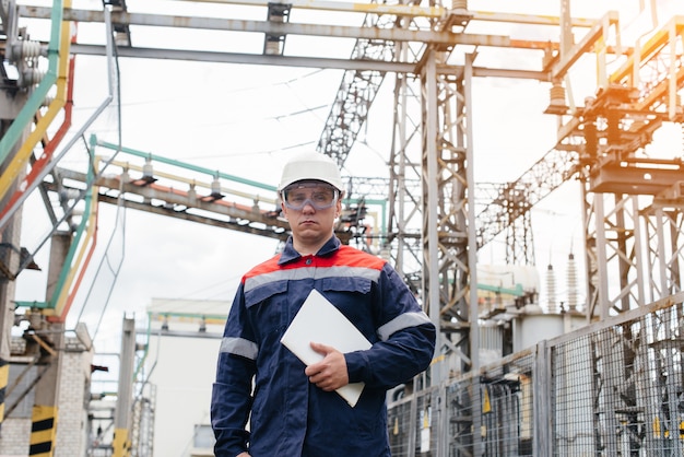 The energy engineer inspects the equipment of the substation. Power engineering. Industry.