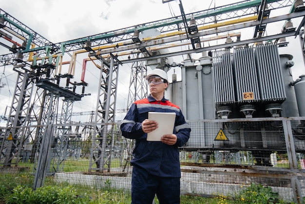 The energy engineer inspects the equipment of the substation. Power engineering. Industry.