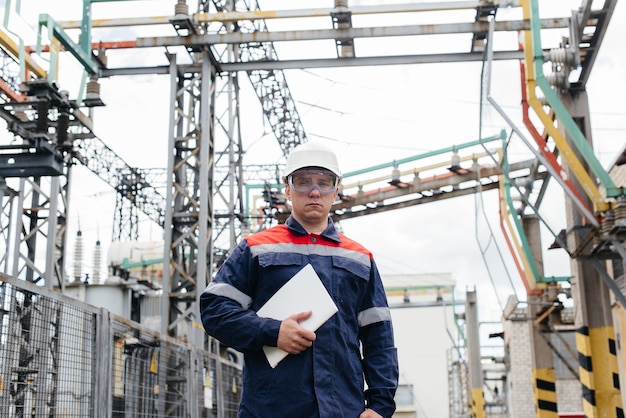 The energy engineer inspects the equipment of the substation. Power engineering. Industry.