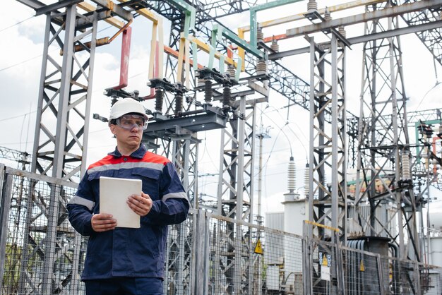 The energy engineer inspects the equipment of the substation