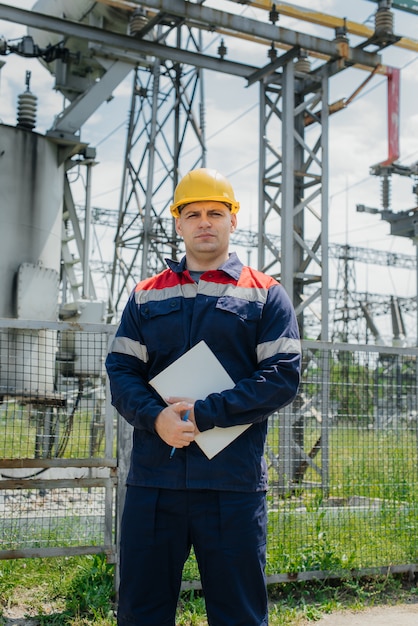 The energy engineer inspects the equipment of the substation.