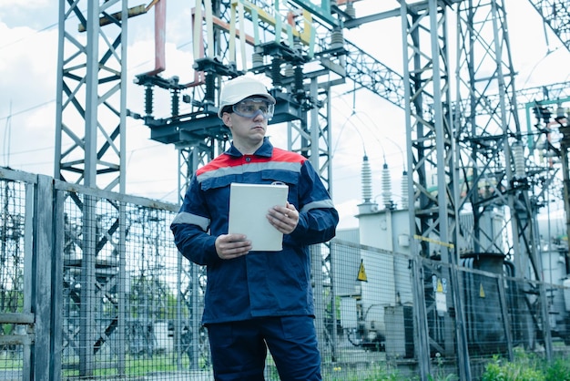 An energy engineer inspects the modern equipment of an electrical substation before commissioning Energy and industry Scheduled repair of electrical equipment