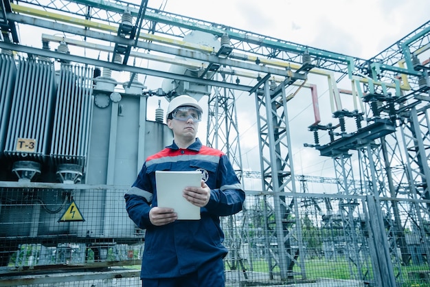 An energy engineer inspects the modern equipment of an electrical substation before commissioning Energy and industry Scheduled repair of electrical equipment