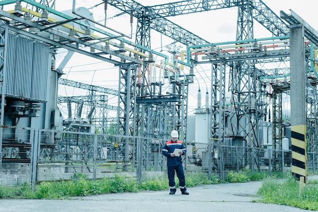 An energy engineer inspects the modern equipment of an electrical substation before commissioning Energy and industry Scheduled repair of electrical equipment