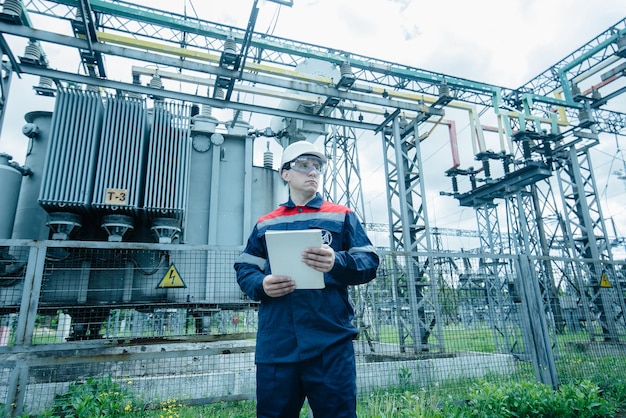 An energy engineer inspects the modern equipment of an electrical substation before commissioning Energy and industry Scheduled repair of electrical equipment