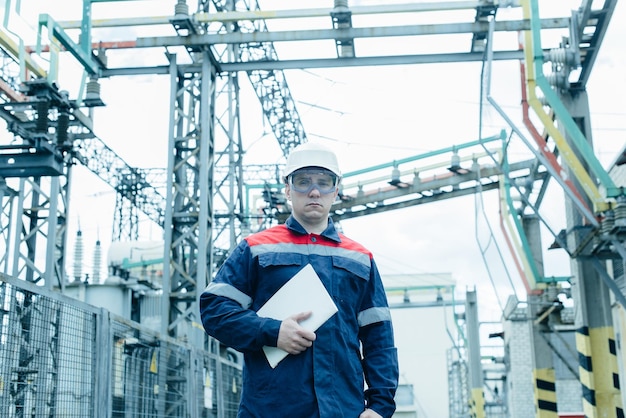 An energy engineer inspects the modern equipment of an electrical substation before commissioning Energy and industry Scheduled repair of electrical equipment