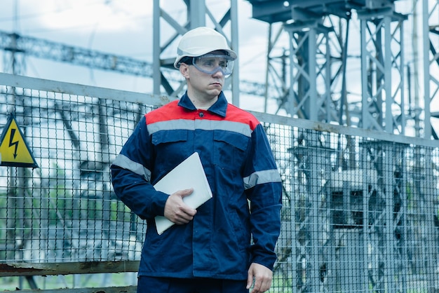 An energy engineer inspects the modern equipment of an electrical substation before commissioning Energy and industry Scheduled repair of electrical equipment