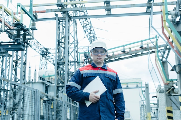 An energy engineer inspects the modern equipment of an electrical substation before commissioning Energy and industry Scheduled repair of electrical equipment