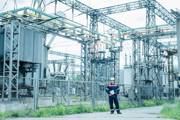 An energy engineer inspects the modern equipment of an electrical substation before commissioning Energy and industry Scheduled repair of electrical equipment