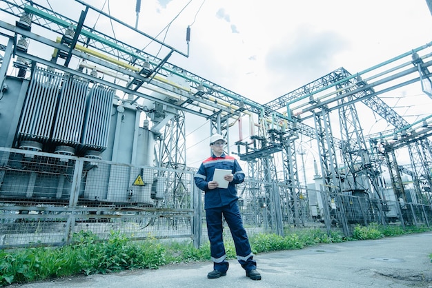 An energy engineer inspects the modern equipment of an electrical substation before commissioning Energy and industry Scheduled repair of electrical equipment