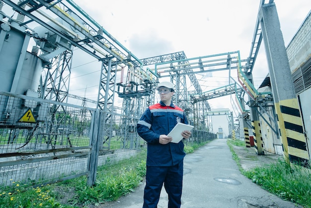 An energy engineer inspects the modern equipment of an electrical substation before commissioning Energy and industry Scheduled repair of electrical equipment