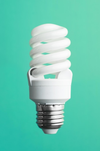 Energy saving light bulb over green background