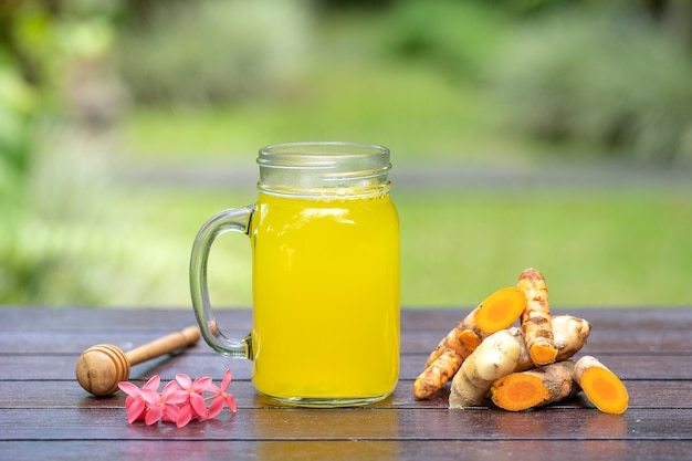 Energy tonic drink with turmeric, ginger, lemon and honey in glass mug