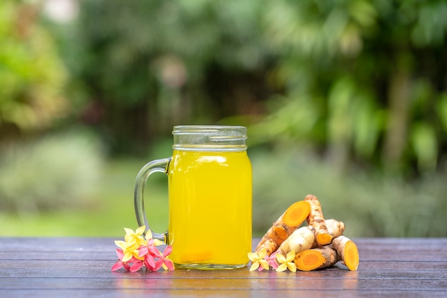 Energy tonic drink with turmeric, ginger, lemon and honey in glass mug