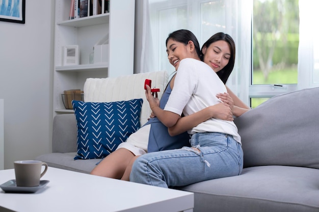 Engaged women couple hugging each other lovingly in living room LGBT Lesbian couple love moments happiness concept