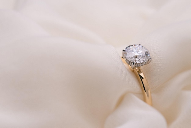 Engagement Diamond Ring on Soft White Fabric Background