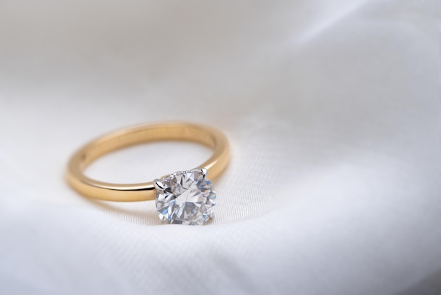 Engagement Diamond Ring on Soft White Fabric Background