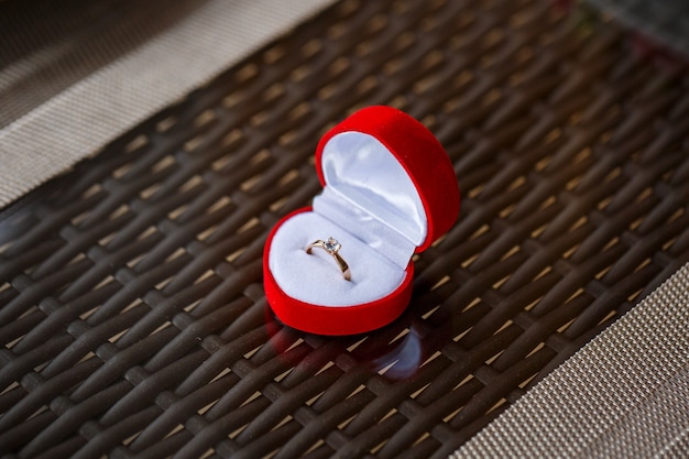 Engagement gold precious jewelry ring in a red box