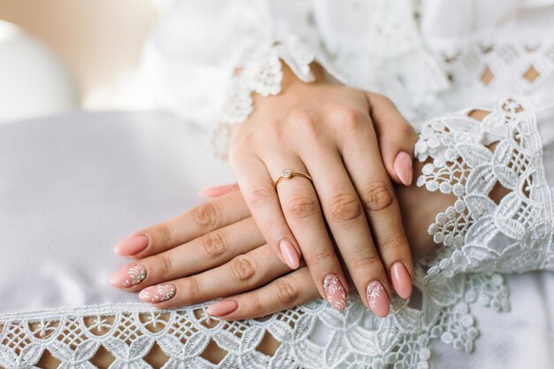 Engagement ring on bride's finger Beautiful lace on the dress