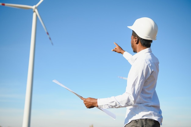 Engineer African man standing with wind turbine