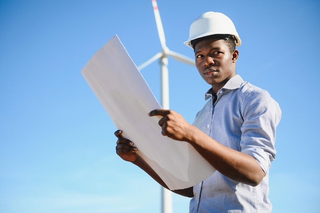 Engineer African man standing with wind turbine