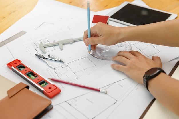 Engineer and Architect concept, Engineer Architects  and Interior designer working with blueprints