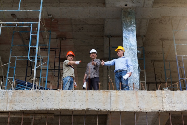 Engineer and Architect working at Construction Site.