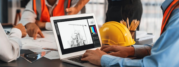 Photo engineer and architect working together brainstorming and designing blueprint using laptop working with architectural software for precise digital interior or structure design insight