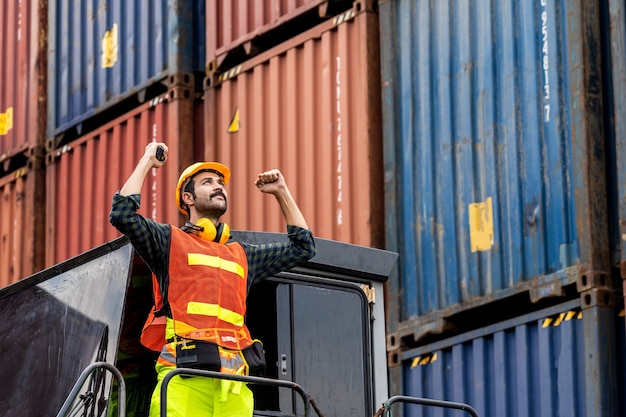 Engineer beard man standing with ware a yellow helmet to control loading