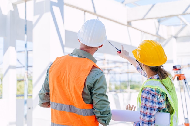 Engineer builder architect team working check roof beam construction progress structure building