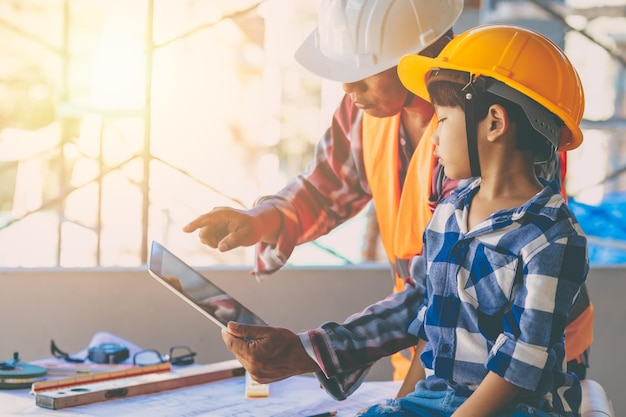 Engineer builder family father day role play teaching son kid at construction site