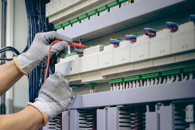 Engineer checks the operation of electrical control equipment, maintenance concept.