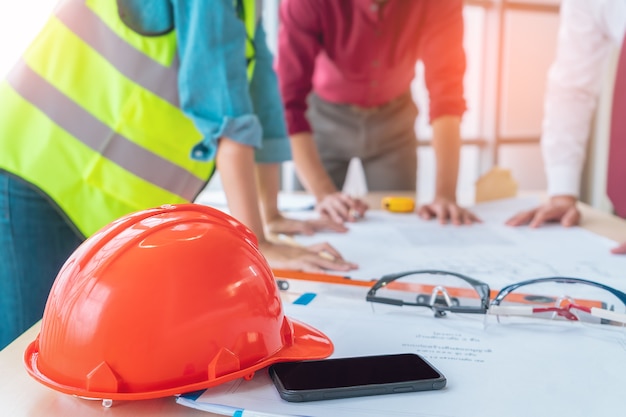 Engineer construction hat on meeting table for industry meeting.