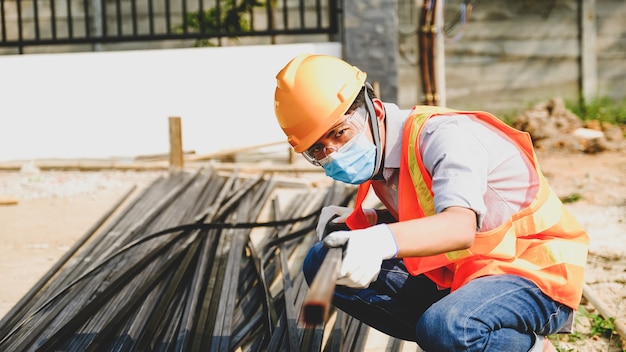 Engineer contractor man work safety industry project, check investigating the size and quality of steel used in building construction structures site.