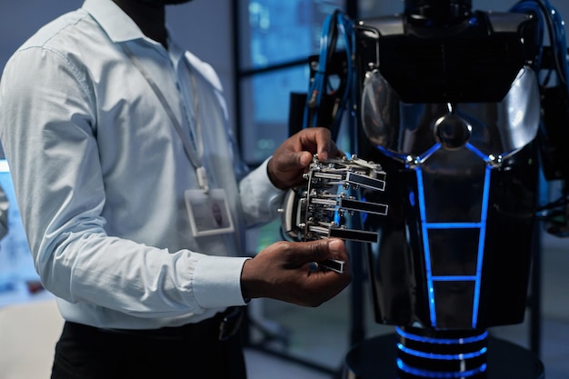 Engineer examining the structure of robot