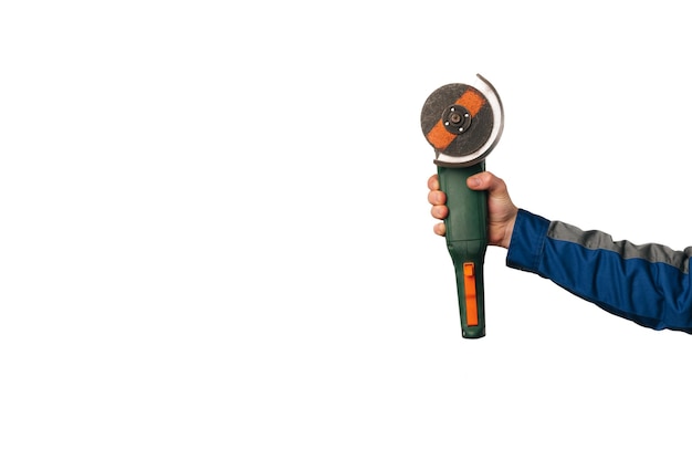 Engineer hand wearing blue uniform is holding an angle grinder electric tool